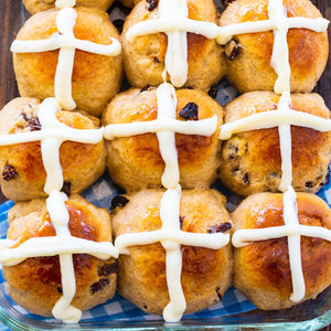 Hot Cross Buns are wonderfully spiced yeast bread rolls studded with raisins and drizzled with cream cheese glaze in the form of a cro
