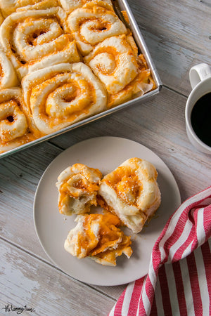 Fluffy, cheesy, and just the right amount of spicy, these Sriracha Cheese Swirl Buns are downright addictive! Make them as is or customize with flavor add-ons to your heart’s delight
