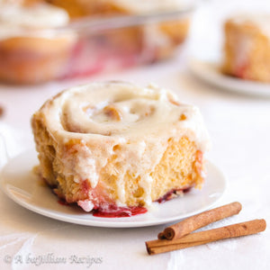 Soft and fluffy cinnamon rolls loaded with sweet raspberries and smothered in mascarpone icing!