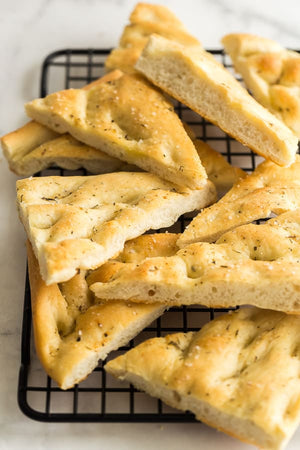 This Focaccia Bread recipe is easier than you think! Made with just a few ingredients and brushed with olive oil and Italian herbs, it’s the perfect complement to any meal!